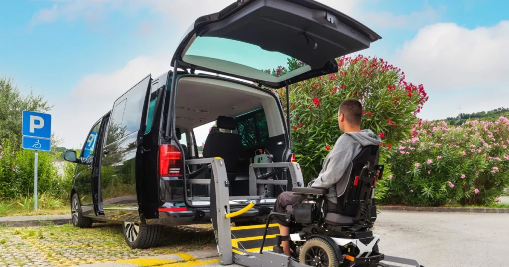 Man in an electric wheelchair entering a black handicap-accessible van, a reliable Medical Transport Service in Pearl River, NY.