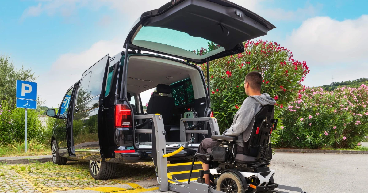 Man in an electric wheelchair entering a black handicap-accessible van, a reliable Medical Transport Service in Pearl River, NY.